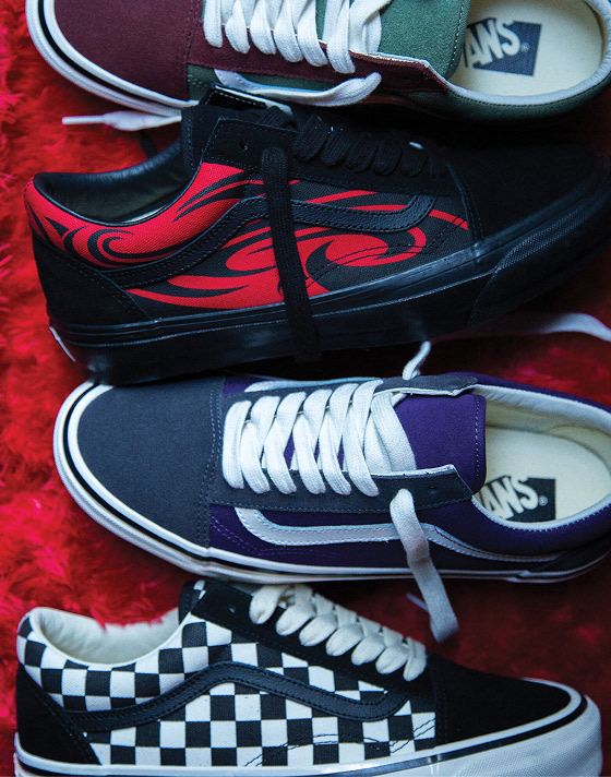 Old Skool Checkerboard shoes laying on red fabric.