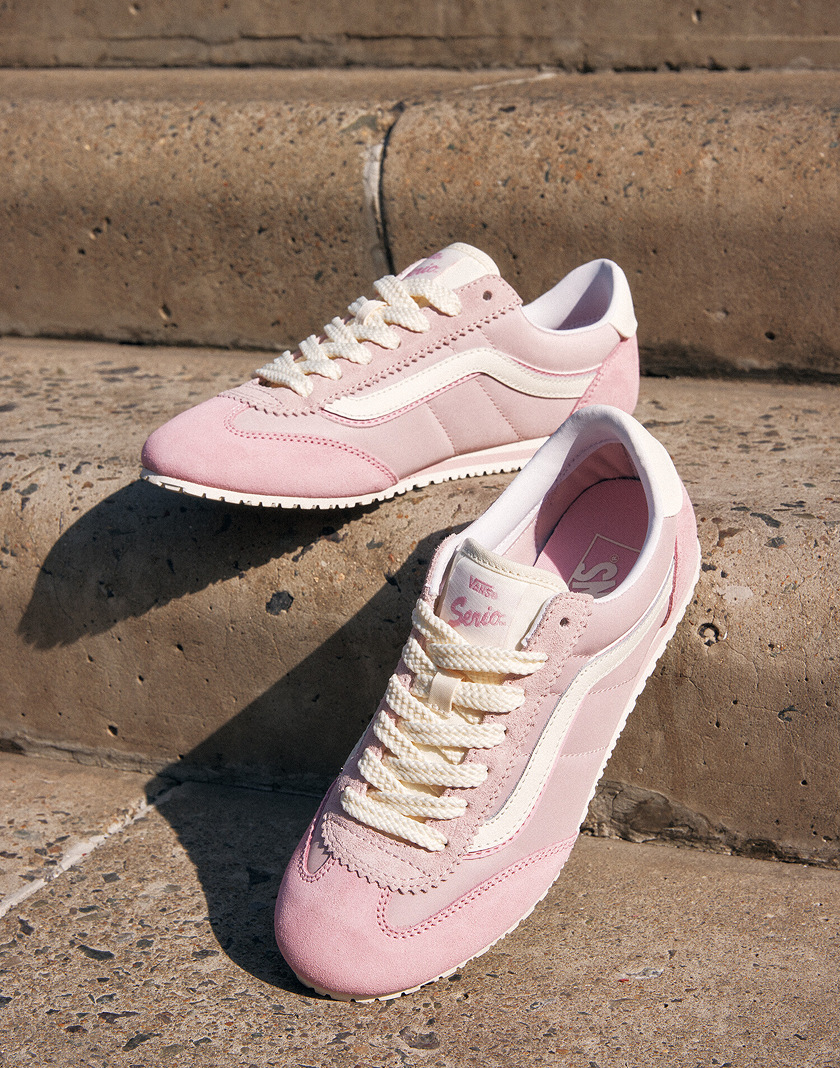 A pair of Sepia Rose Vans Super Lowpro sneakers with white laces are displayed on concrete steps. 
