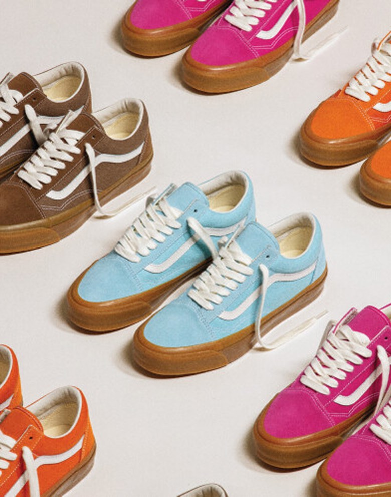 Many pairs of the Premium Old Skool Music Collection laid out on a floor in three colorways.