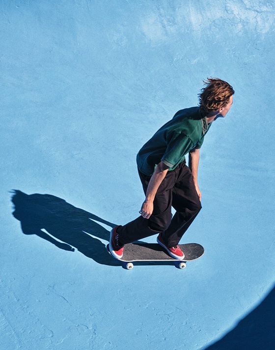 Vans athlete Curren Caples skates down into a bowl wearing red Curren skate shoes.