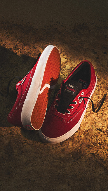 An overhead shot of the Curren in the red colorway with some golden lighting.