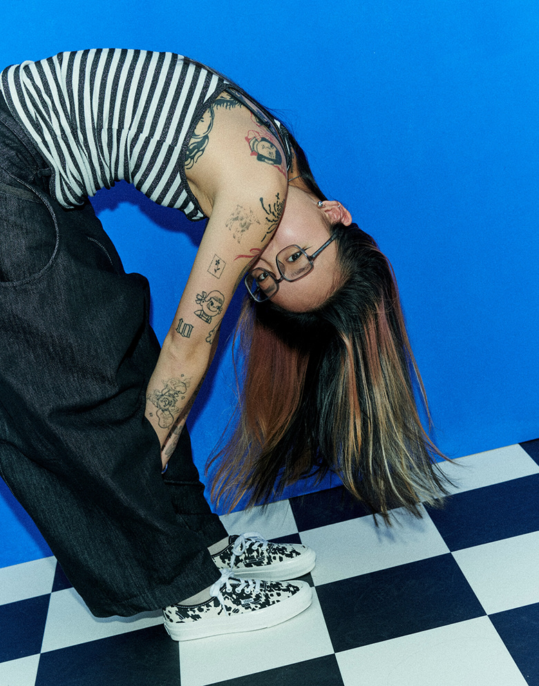 A person wearing cow print Authentic Vans. 