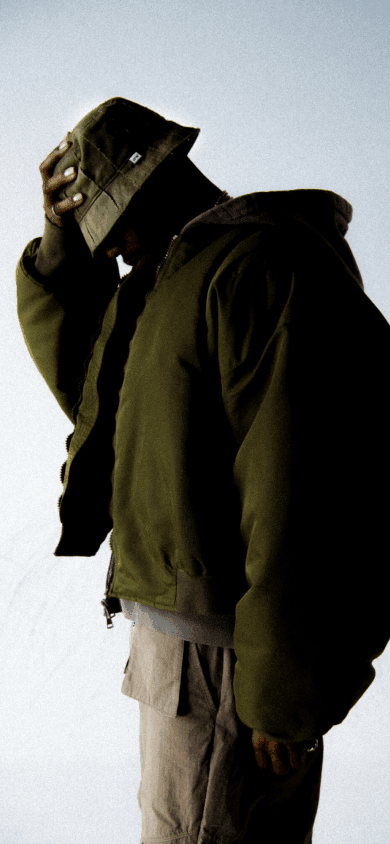 A blurry image of a man wearing an OTW bucket hat. 