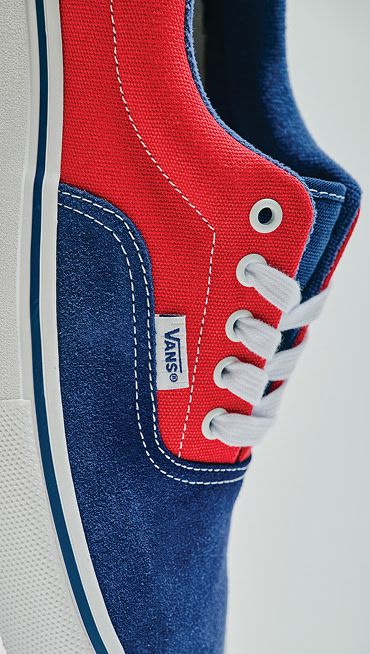 Extreme close up of the Blue / Red Skate Era Shoe showing off the white stitching and the suede toe box.