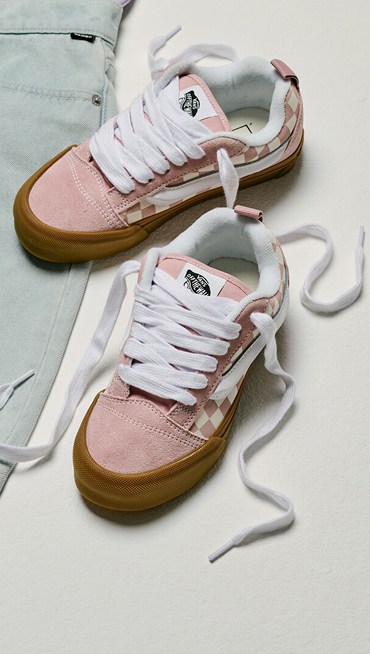 An overhead shot of Gum Checkerboard Misty Mauve Pink Big Kids Knu Skool on the floor of a photography studio.