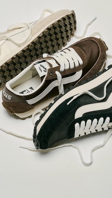 All three white, black, and brown colorways of the Premium Style 152 laid out on the floor of a photography studio.