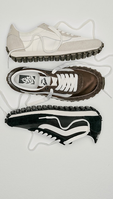 An overhead shot of all three white, black, and brown colorways of the Premium Style 152 laid out on the floor of a photography studio.
