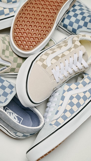Various pastel colorways on the Checkerboard Old Skool and Classic Slip-On in a pile on the floor.
