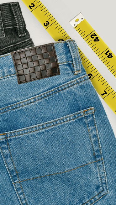 A pair of black and a pair of stonewash blue Check-5 Baggy Denim Pants stacked on top of each other.