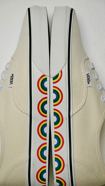 Close-up on the archival sidewall rainbow graphics on the marshmallow white Authentic.
