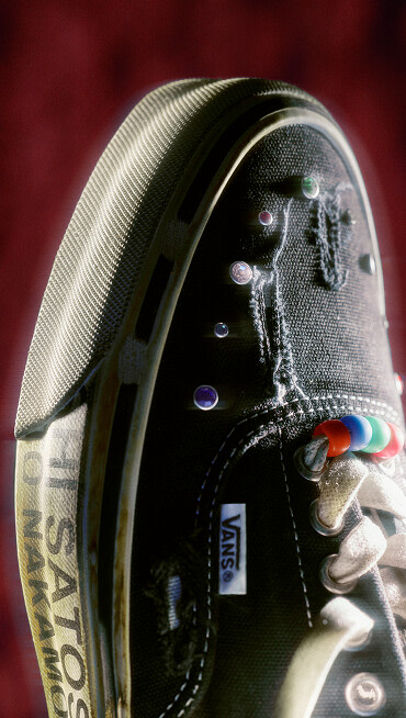 A close up image of the OTW x SATOSHI shoe with a red velvet background.