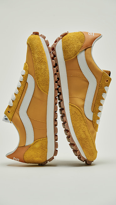 A pair of yellow Style 152 lean up against each other in a photo studio.
