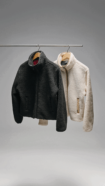 Several fuzzy Classic Slip-On stacked on top of each other so you can see the logos in the soles.