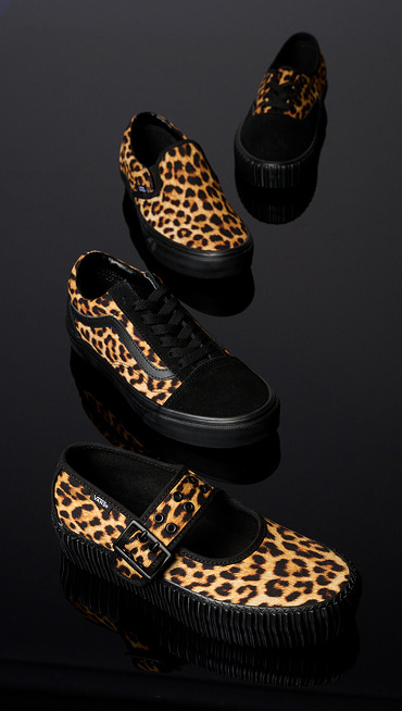 Studio shot of various Vans shoe styles in leopard print.