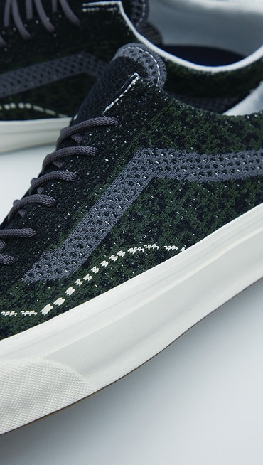 A close-up of the knitted texture on the Cheetah Dried Kelp Green Premium Old Skool.