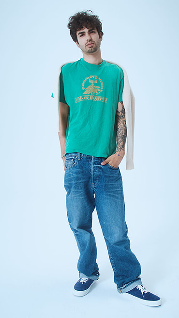 Pablo, a designer, poses in a photography studio wearing blue pig suede Premium Authentic on Open Set Los Angeles.