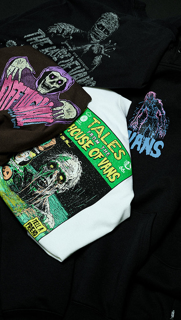 A selection of Vans Halloween t-shirts stacked on top of each other.