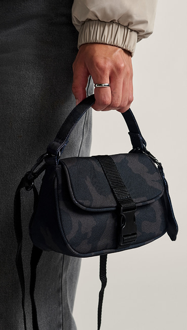 A close-up of the Hooked On Mini Bag in black camo.