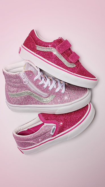 Glittery pink velcro Old Skool, Sk8-Hi, and Classic Slip-On rest on the floor together.