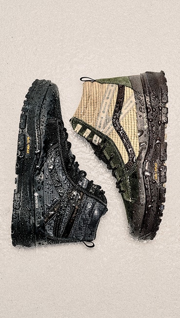 An overhead shot of a black MTE Sk8-Hi GORE-TEX and a white and green one covered in water.