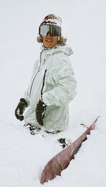 A close-up of someone wearing the black Sk8-Hi GORE-TEX and walking on snow with a mountain in the background.