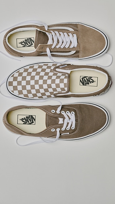 An overhead shot of a brown Old Skool, brown Checkerboard Classic Slip-On, and brown Authentic in a photography studio.