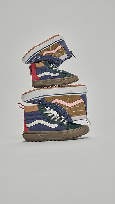 Close-up on the glow-in-the-dark aliens on the Little Kids Classic Slip-On Shoe under an eerie green light for Halloween.