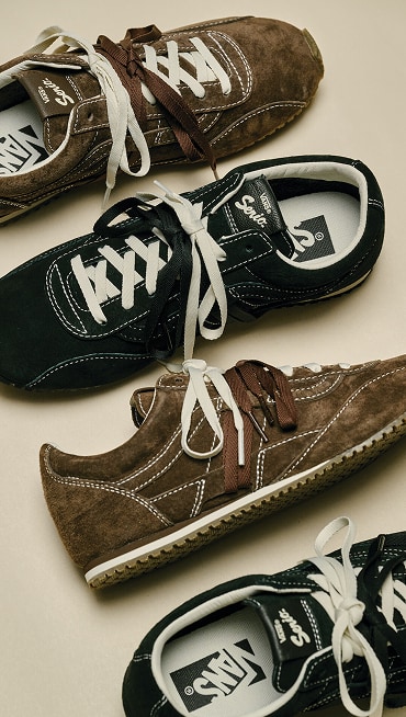 An overhead shot of a pair of brown and a pair of black Super Lowpro Trainers.