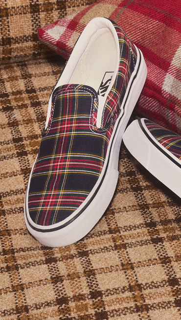 A pair of plaid Slip-On on a seventies-styled plaid sofa for a holiday atmosphere.