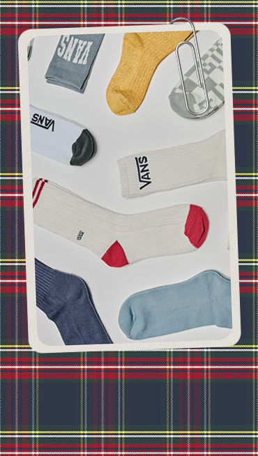A paperclipped card with an image of various Vans socks on a plaid holiday background.