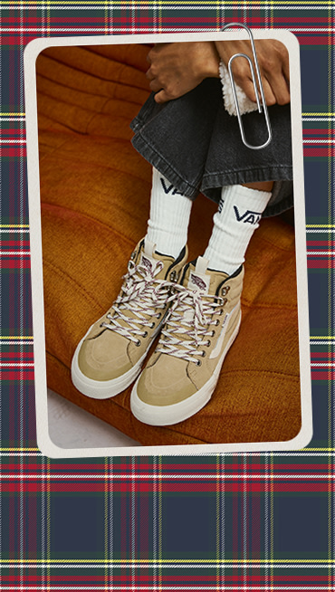 A paperclipped card with an image of a pair of Sk8-Hi Waterproof Insulated shoes on an orange sofa on a plaid holiday background.