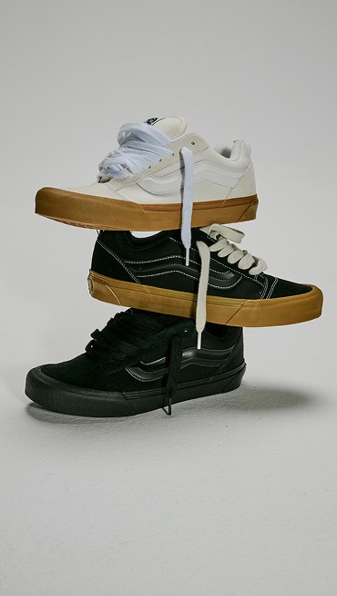 Three Knu Skool Shoes stacked on top of one another. Top is the Blanc De Blanc White, middle is the Gum Black, bottom is the Black.