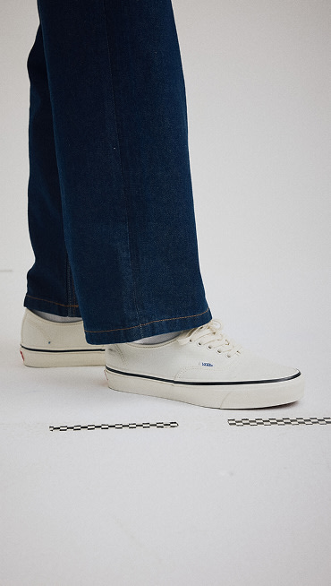 Wide shot of a man wearing the Premium Authentic Shoe in Marshmallow White.
