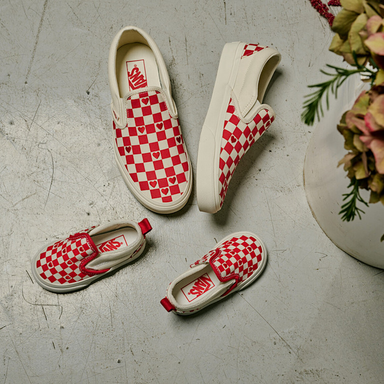 Overhead shot of the racing red Checkerboard Classic Slip-On with red hearts from the Van’s Valentine’s Day Collection.