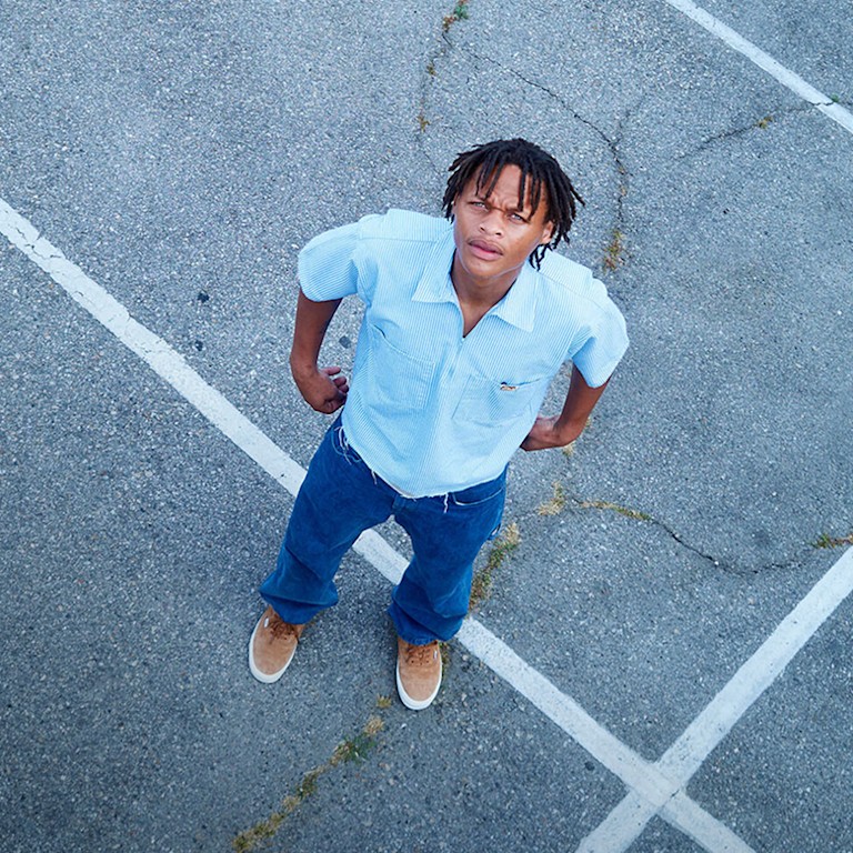 An overhead shot of skater Hadrian in a parking lot wearing pig suede Premium Authentic on the set of Open Set Los Angeles.