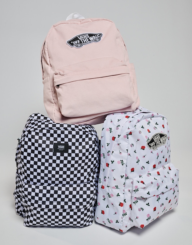 Three Kids Old Skool Grom Backpacks stacked on top of each other in a photography studio.