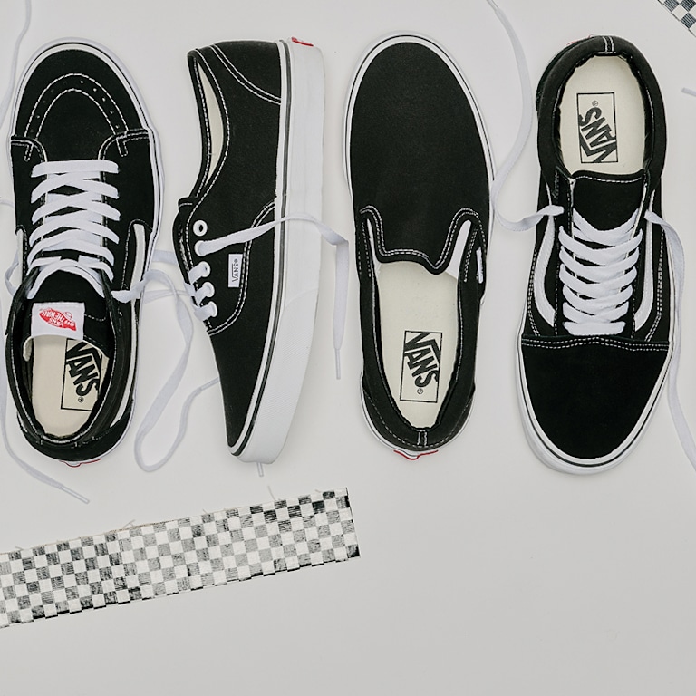 An overhead shot of the Sk8-Hi, Authentic, Classic Slip-On, and Old Skool in black and white colorways on a white floor.