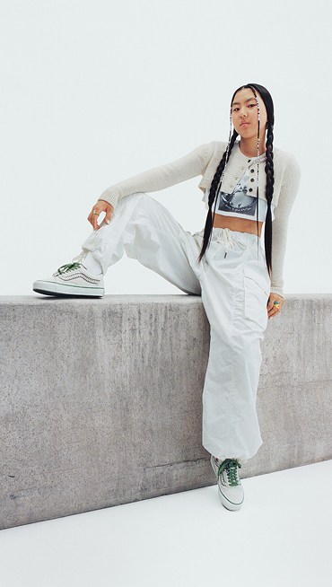 Vans Skater Cocona Hiraki poses in a photography studio wearing all white and her Premium Old Skool from the New Future collection.