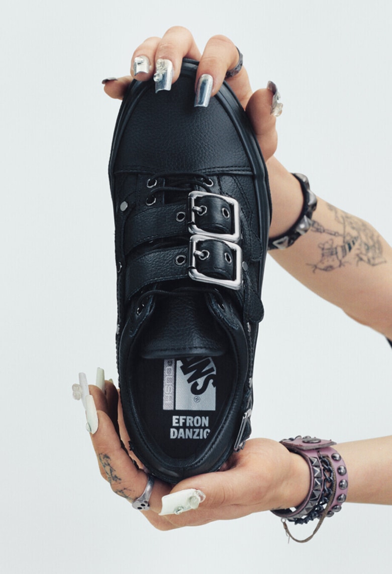 Vans Skater Efron Danzig holds up her Premium Old Skool in a photography studio with her name on the interior sole.