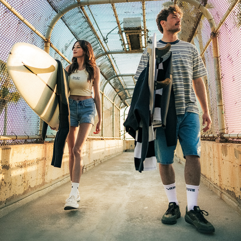 Vans Surf Team Riders Maddie Miller and Micky Clarke crossing a pedestrian bridge wearing the UltraRange 2.0.