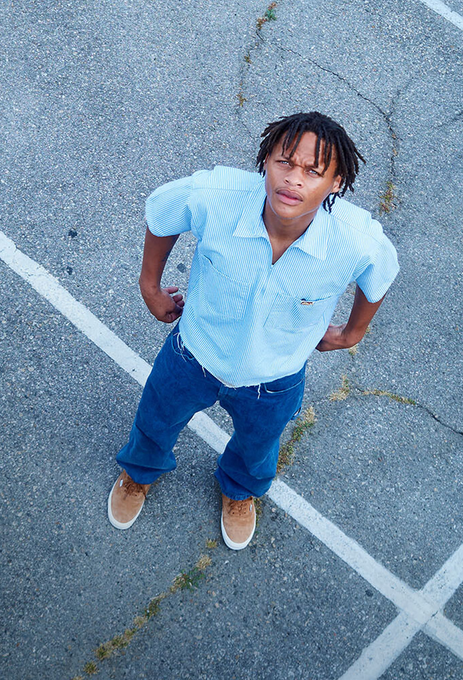 An overhead shot of skater Hadrian in a parking lot wearing pig suede Premium Authentic on the set of Open Set Los Angeles.