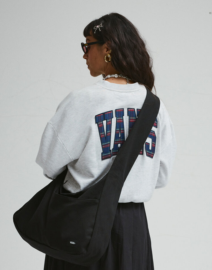 A woman poses in a photography studio with her back to the camera wearing a Tartan Up Retro Crew Sweatshirt.