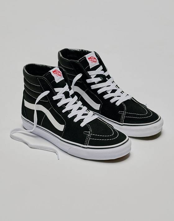 A pair of black and white Sk8-Hi in a photography studio.