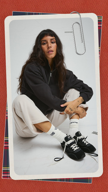 A photograph surrounded by a red holiday border of a young woman wearing black Super Lowpro in a photography studio.