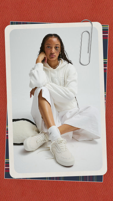 A photograph surrounded by a red holiday border of a young woman wearing pearlized white Old Skool.