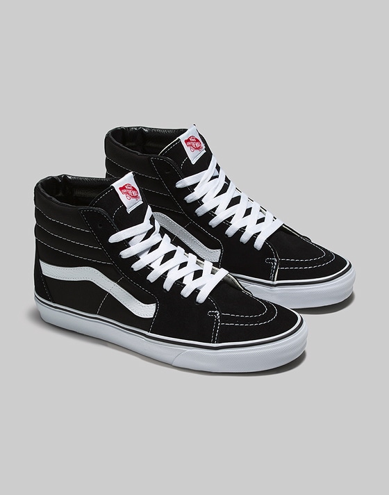 A pair of black and white Sk8-Hi in a photography studio.