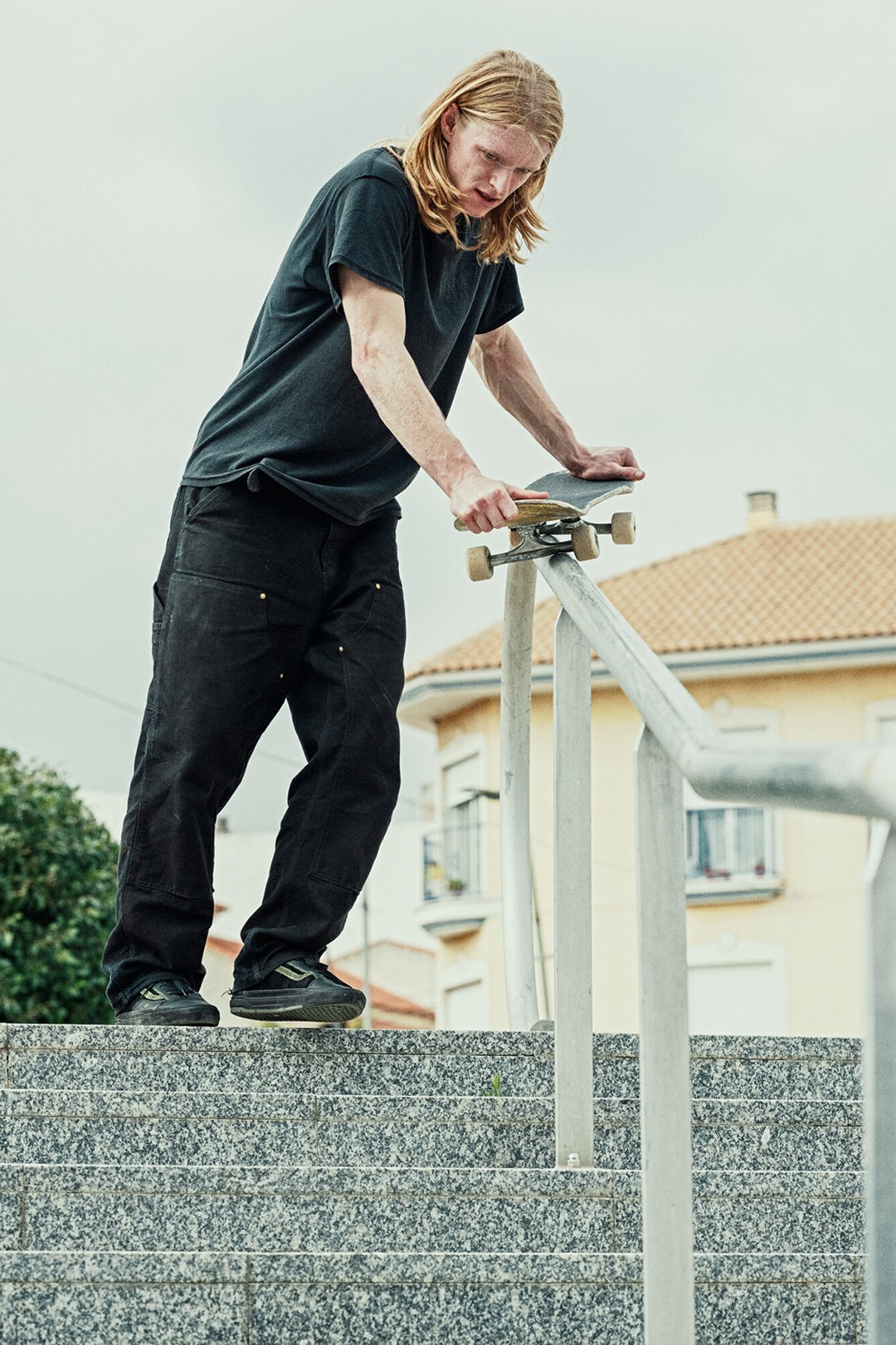 Vans team rider, Willow Voges Fernandes, getting ready to skateboard down a stair rail.