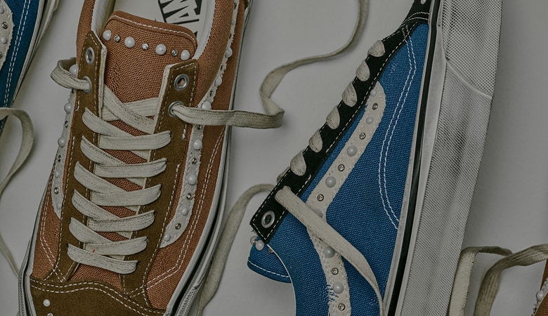 An overhead shot of a blue Premium Old Skool 36 Pearlized shoe next to a brown Premium Old Skool Pearlized shoe.