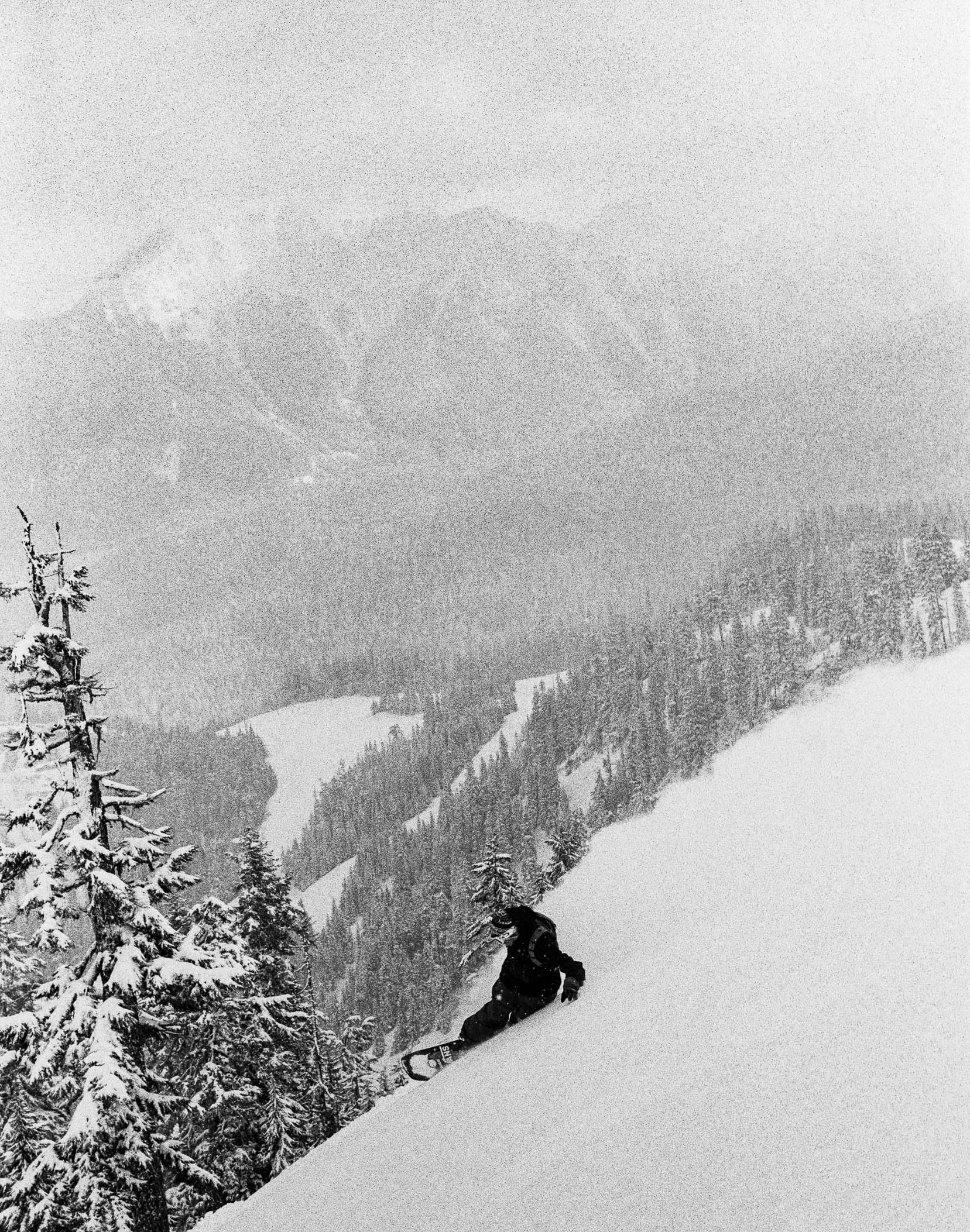 Image of Vans Snowboarding athlete snowboarding on a mountain. 