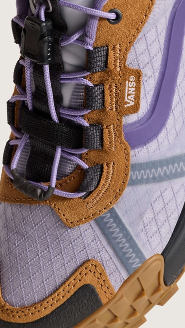 A close-up shot of the stitching and laces on the purple and brown MTE Crosspath